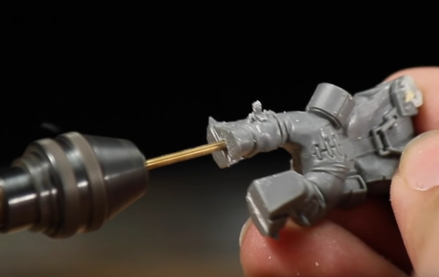 Drill a hole through the bottom of your miniature with a pin vise drill